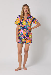 A lady wearing BedHead x Trina Turk Bay Street Bloom Short Sleeve Classic Shorty Stretch Jersey Pj Set