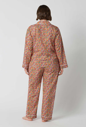 A Lady Wearing Plus Size Nell, Annie, & May Long Sleeve Classic Woven Tana Lawn® Pj Set Made With Liberty Fabrics in a back view pose