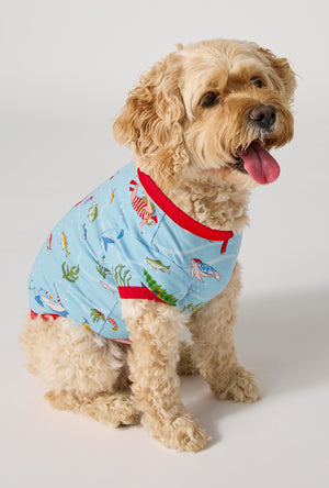 A dog wearing Jingle All The Wave Stretch Jersey Dog Pajama