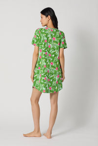 A Lady Wearing Monstera Bloom Stretch Jersey T-shirt Sleep Dress showing the back view of the dress