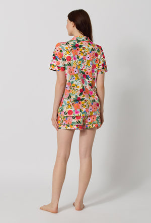 A lady wearing Rifle Paper Co. x BedHead PJs Garden Party Short Sleeve Classic Shorty Stretch Jersey Pj Set back view