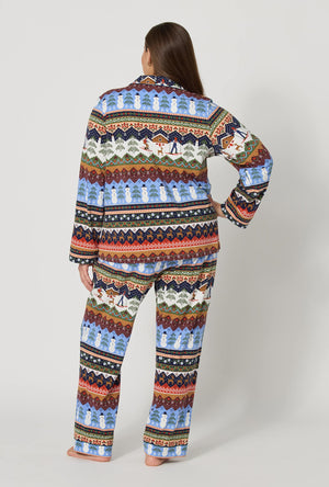A lady wearing plus size Rifle Paper Co. x BedHead PJs Ski Chalet Long Sleeve Classic Stretch Jersey Pj Set back view