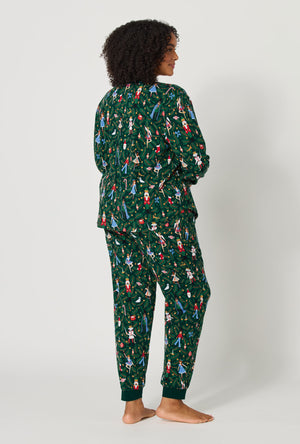 A lady wearing plus size Rifle Paper Co. x BedHead PJs Nutcracker Long Sleeve Pullover Crew And Jogger Stretch Jersey Pj Set back view