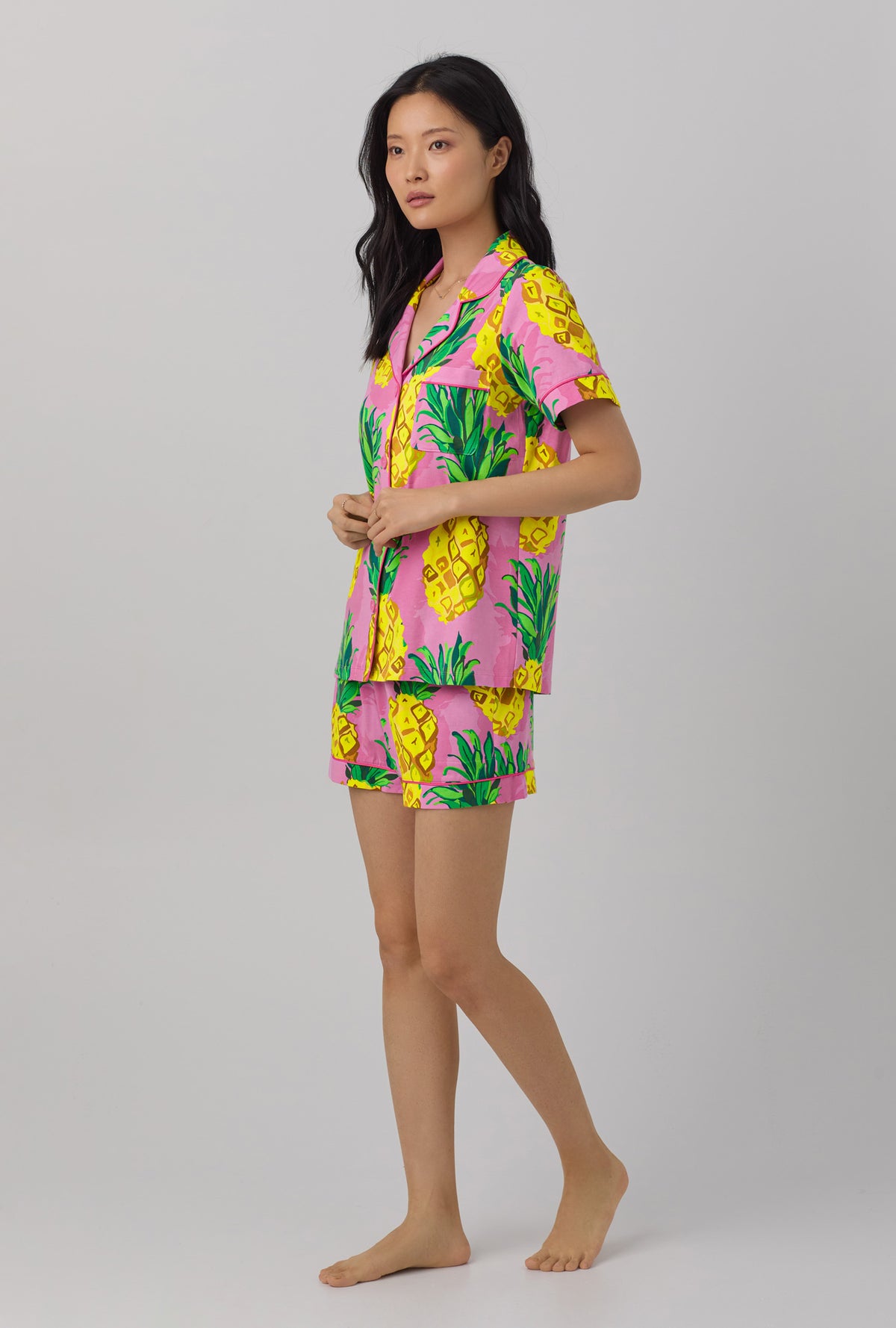 A lady wearing short sleeve classic shorty stretch jerset pj set with pineapple print