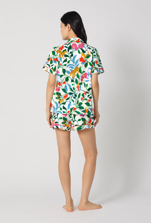 A Lady Wearing Jungle Serenade Short Sleeve Classic Shorty Stretch Jersey Pj Set facing back in a standing pose