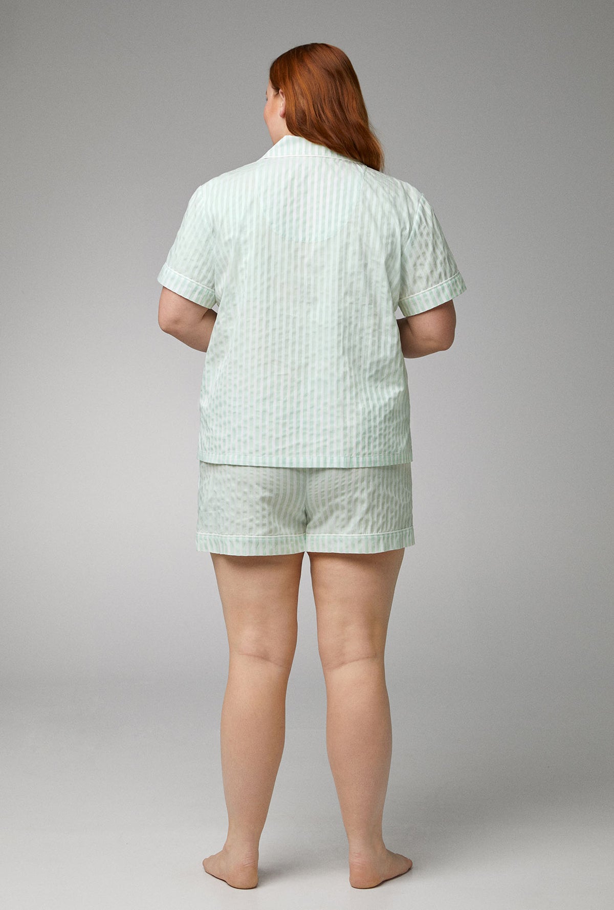 A lady wearing green Short Sleeve Classic Woven Cotton Sateen Shorty PJ Set with Mint 3D Stripe print