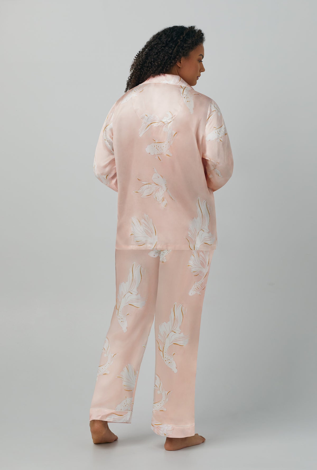 A lady wearing Long Sleeve Classic Washable Silk PJ Set with koi pond print