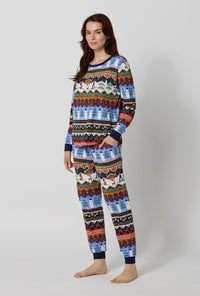 A lady wearing Rifle Paper Co. x BedHead PJs Ski Chalet Long Sleeve Pullover Crew And Jogger Stretch Jersey Pj Set