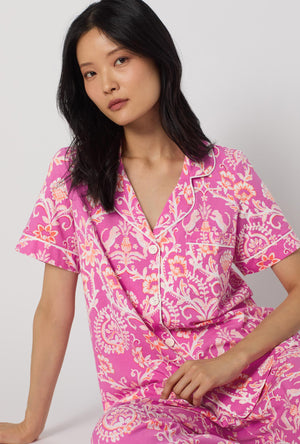 A Lady Wearing Luxe Leopard Short Sleeve Classic Stretch Jersey Cropped Pj Set facing front in a sitting close up pose
