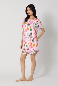 A Lady Wearing Tropical Daydream Stretch Jersey T-shirt Sleep Dress facing to the side in a side angle pose