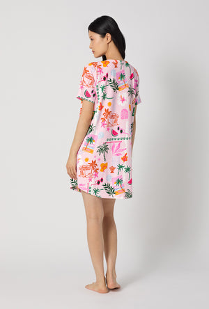 A Lady Wearing Tropical Daydream Stretch Jersey T-shirt Sleep Dress showing the back view of the dress