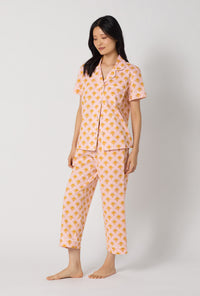 A Lady Wearing Deco Sunset Short Sleeve Classic Woven Cotton Poplin Cropped Pj Set posing in a side angle view