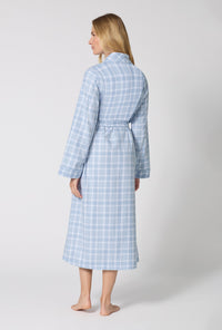 A lady wearing Meadow Haze Plaid Unisex Classic Woven Portuguese Flannel Robe De Chambre back view