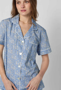 A closeup of A lady wearing Blue Short Sleeve Classic Woven Tana Lawn® Cropped Pj Set Made With Liberty Fabric