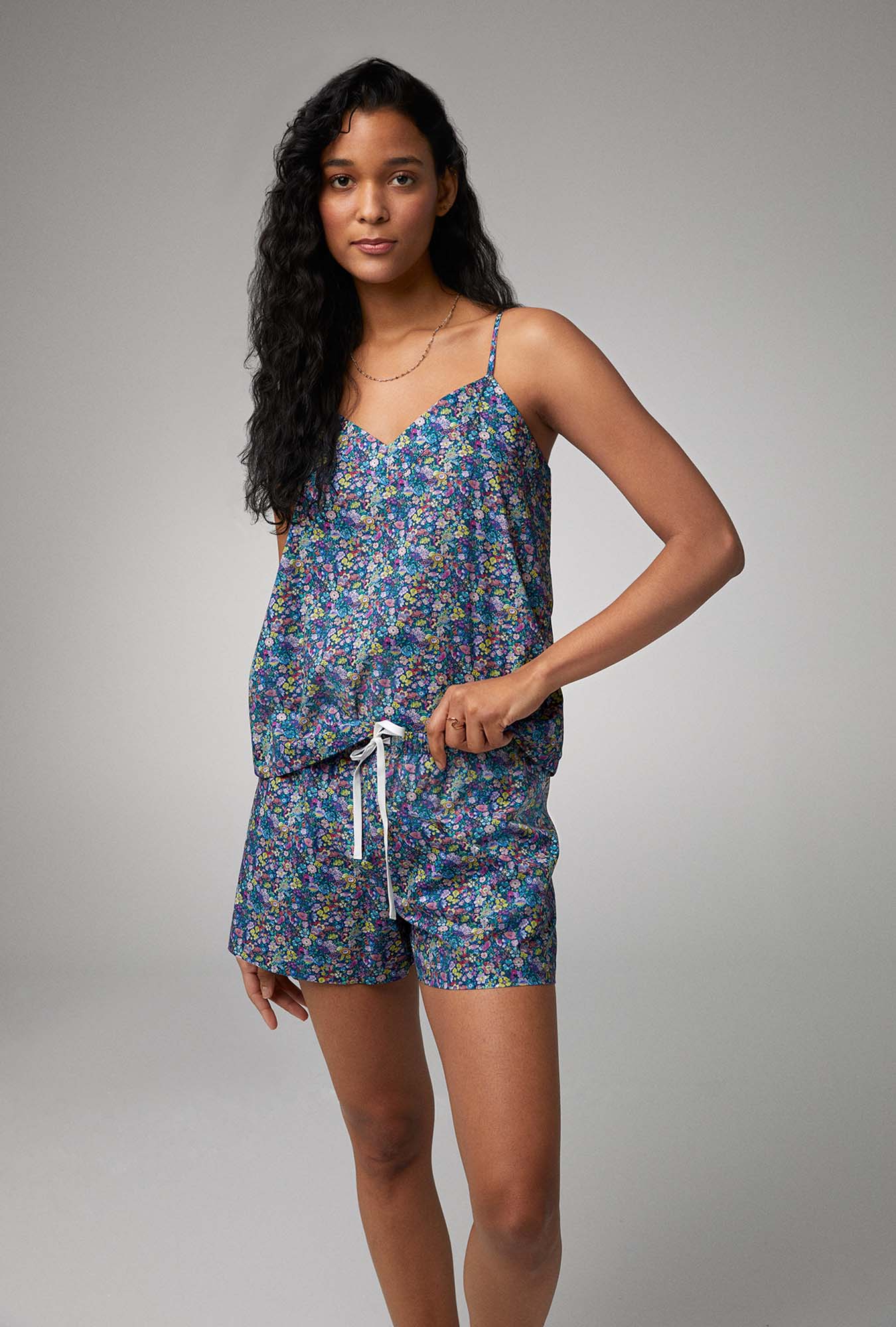 A lady wearing cami shorty pj set with classic garden print