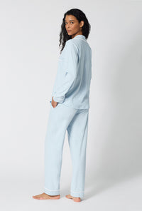 A lady wearing Blissful Blue Long Sleeve Classic Stretch Jersey Pj Set back view