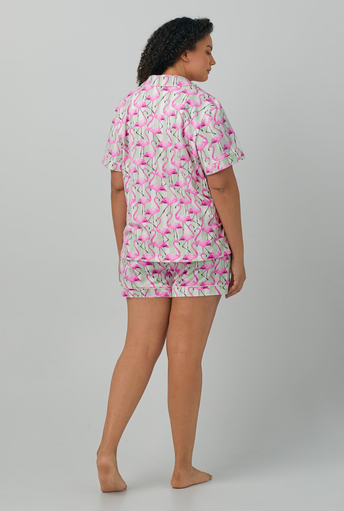 A lady wearing plus size pink Short Sleeve Classic Shorty Stretch Jersey PJ Set with Flamingo Bay print
