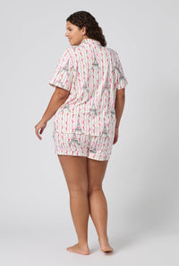 A Lady Wearing Plus Size Fleur De La Tour Short Sleeve Classic Shorty Stretch Jersey Pj Set in a back view pose