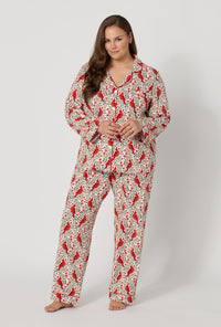 A lady wearing plus size Rifle Paper Co. x BedHead PJs Cardinals Long Sleeve Classic Stretch Jersey Pj Set