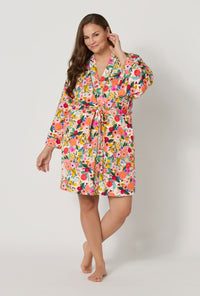 A lady wearing plus size Rifle Paper Co. x BedHead PJs Garden Party Banded Collar Stretch Jersey Robe