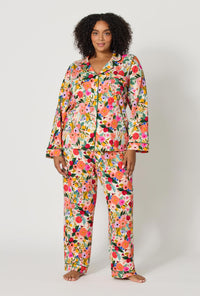 A lady wearing plus size Rifle Paper Co. x BedHead PJs Garden Party Long Sleeve Classic Stretch Jersey Pj Set