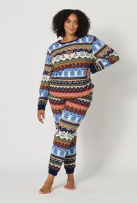 A lady wearing plus size Rifle Paper Co. x BedHead PJs Ski Chalet Long Sleeve Pullover Crew And Jogger Stretch Jersey Pj Set