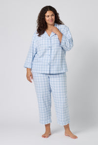 A lady wearing plus size Meadow Haze Plaid 3/4 Sleeve Classic Woven Portuguese Flannel Cropped Pj Set