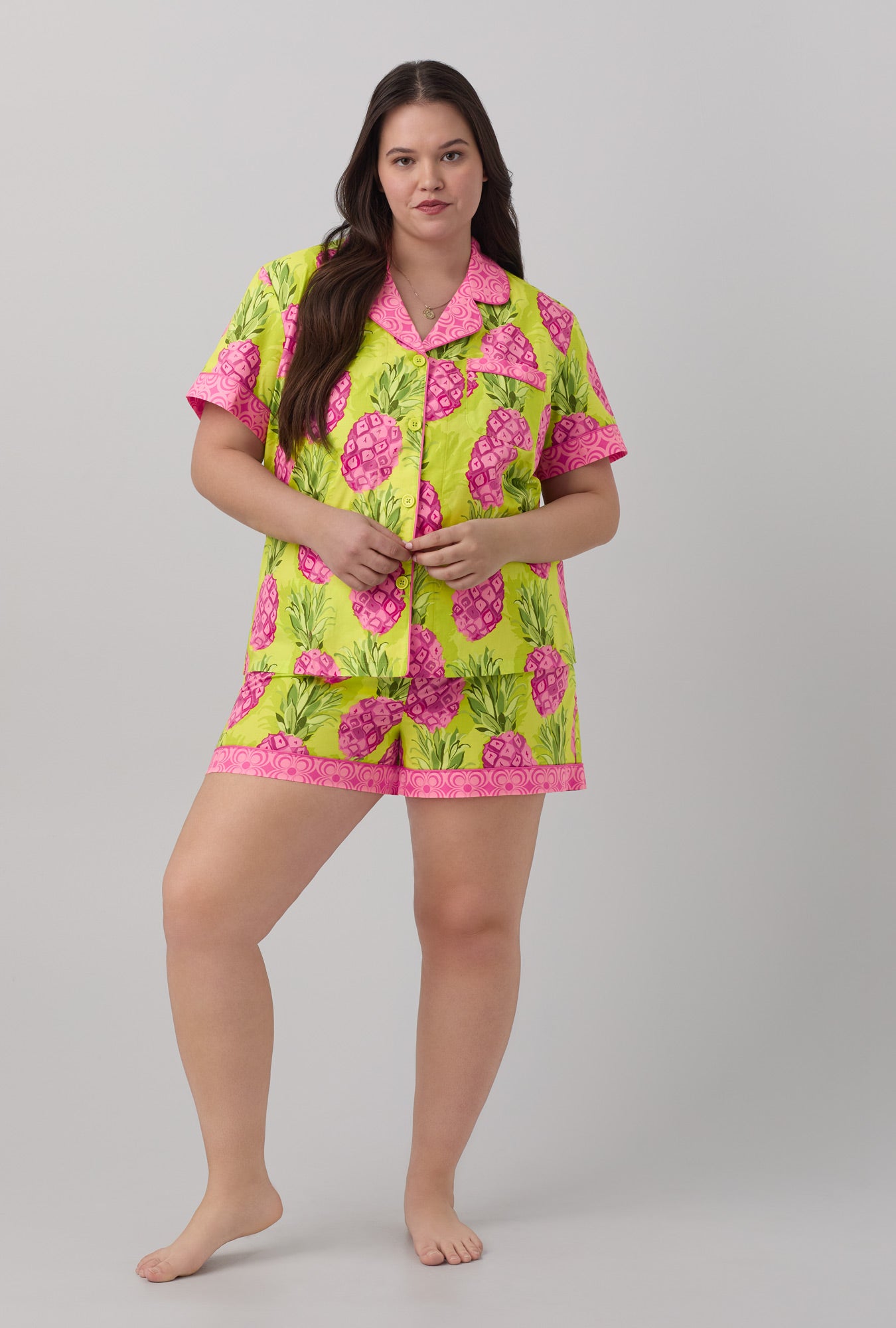 A lady wearing short sleeve classic shorty woven cotton poplin pj set with kiwi pineapple print