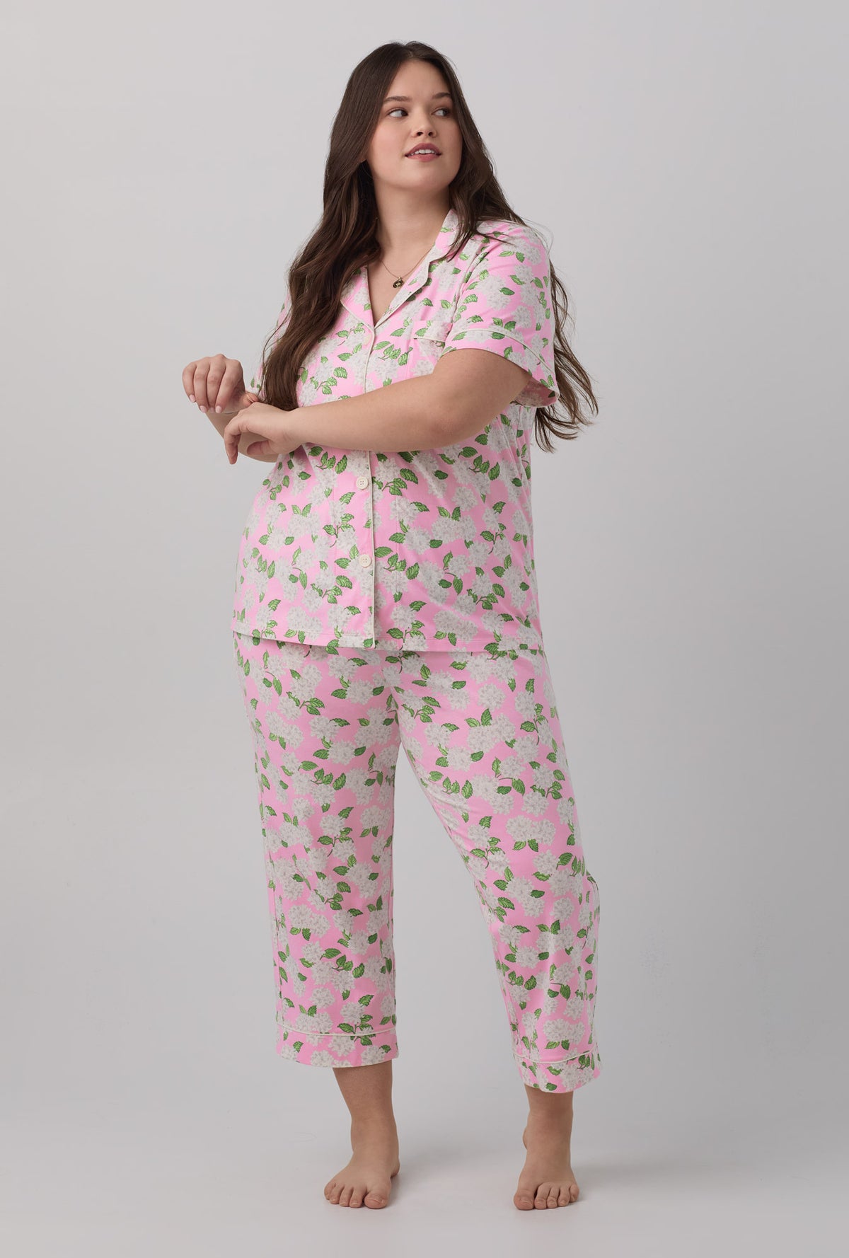 A lady wearing plus size  pink Hydrangea Short Sleeve Classic Stretch Jersey Cropped PJ Set with Pink Summer print.