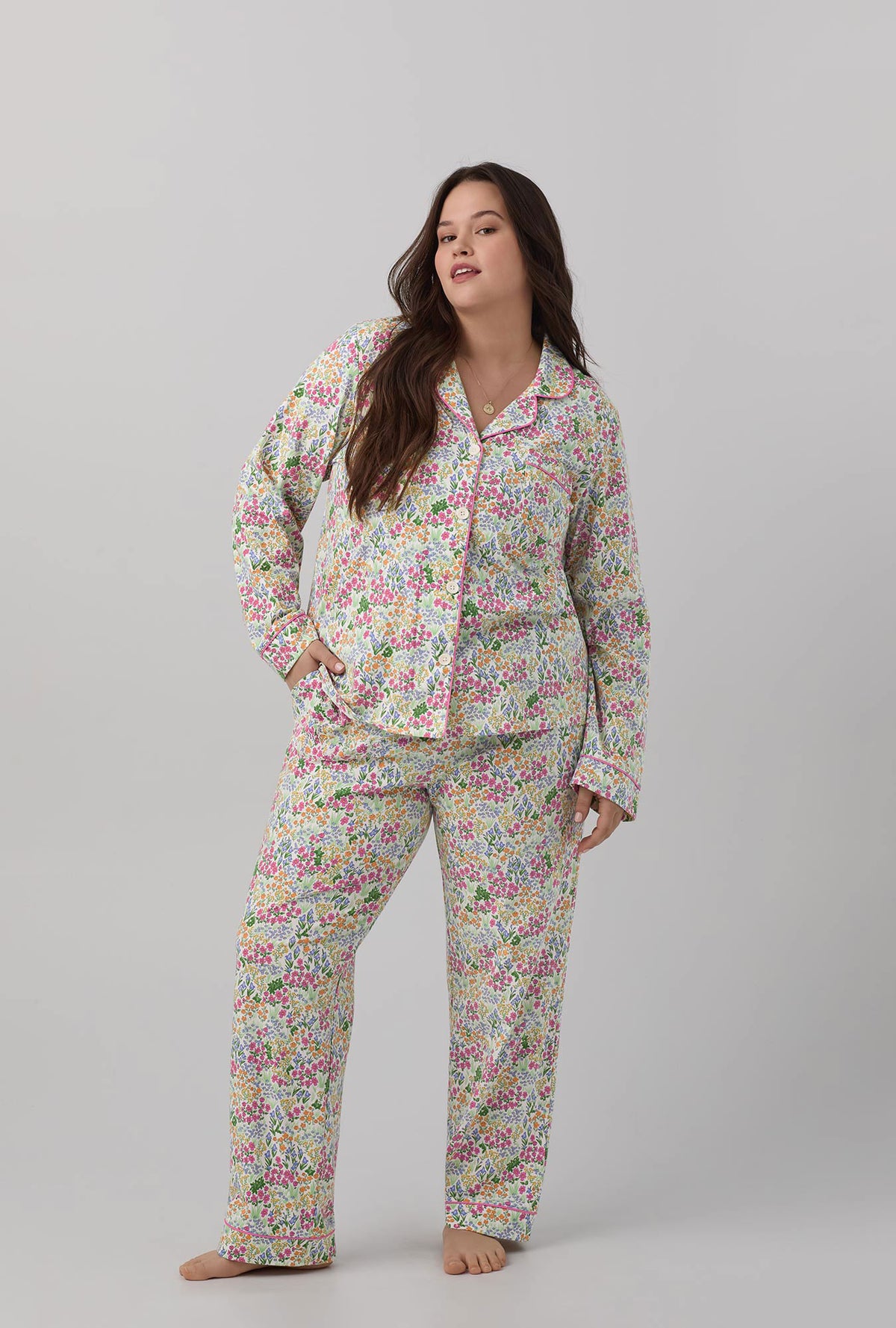 A lady wearing multi color long sleeve classic stretch jersey plus size pj set with cottage garden print.