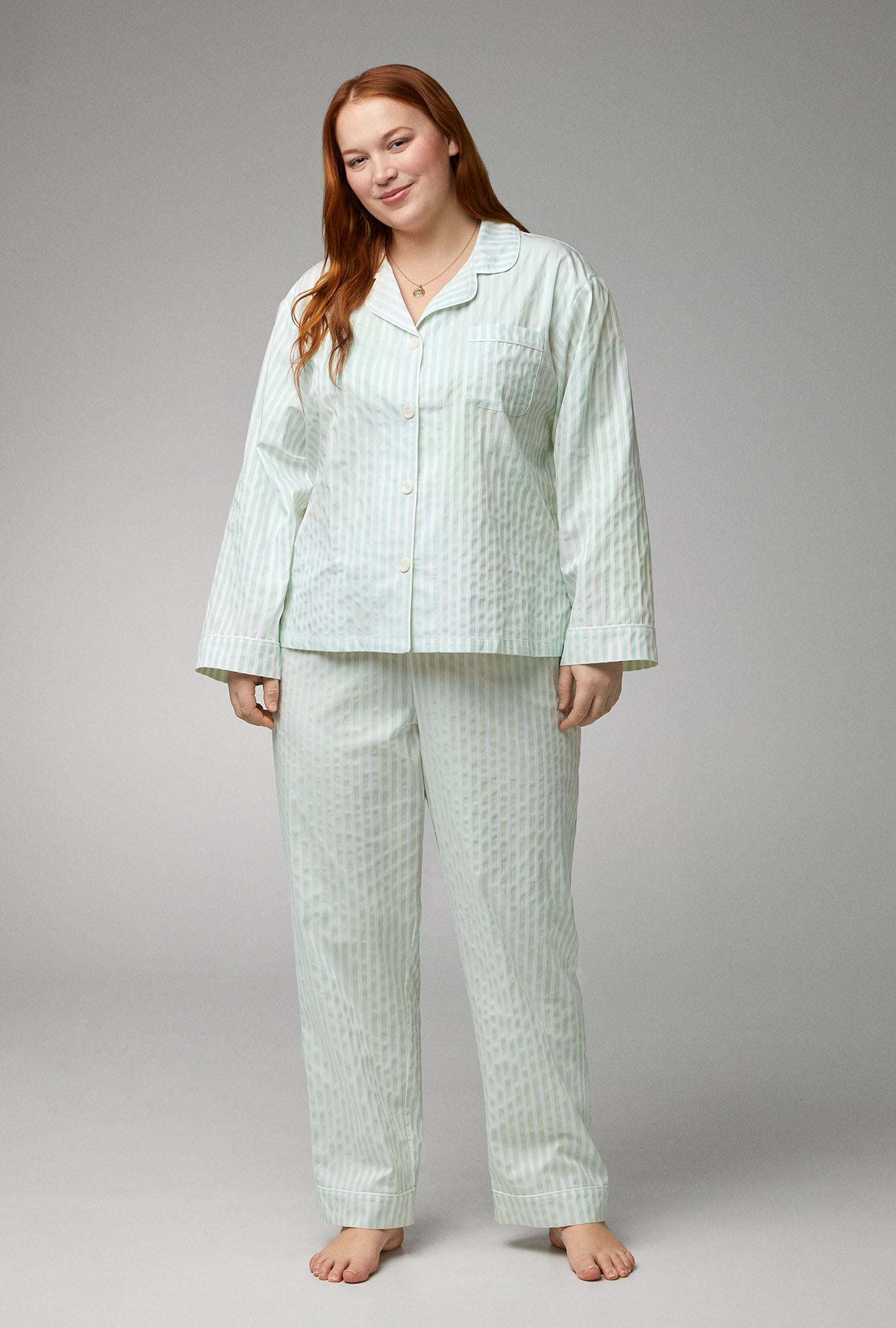 A lady wearing green Long Sleeve Classic Woven Cotton Sateen PJ Set with Mint 3D Stripe print