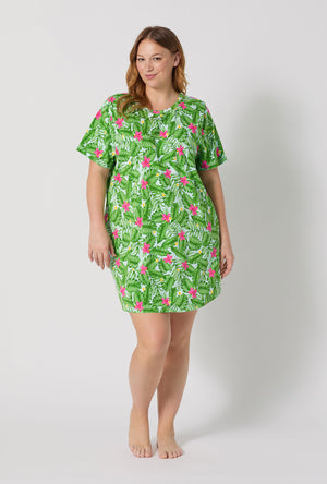 A Lady Wearing Plus Size Monstera Bloom Stretch Jersey T-shirt Sleep Dress posing with a front facing view
