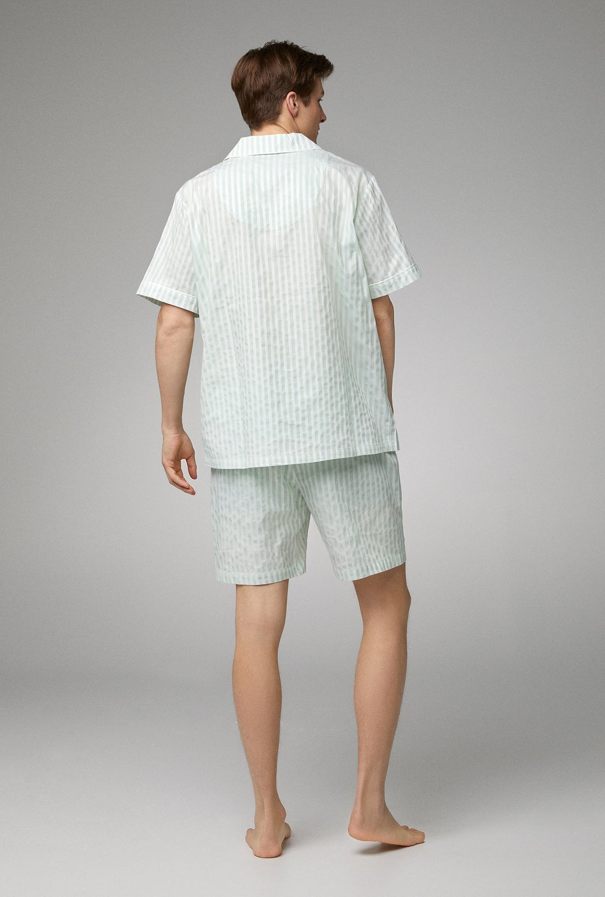 A men wearing  Short Sleeve Notch Woven Cotton Poplin Short PJ Set with Mint 3D Stripe print