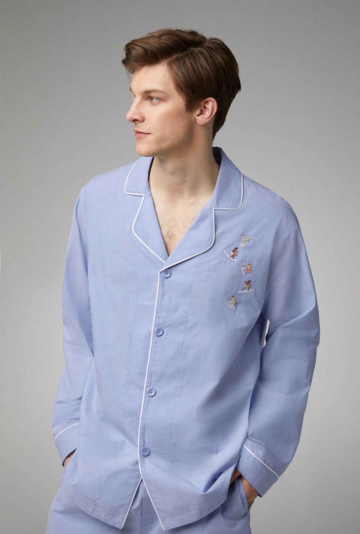 A man wearing blue long sleeve woven cotton poplin boxer short pj set with chambray print.
