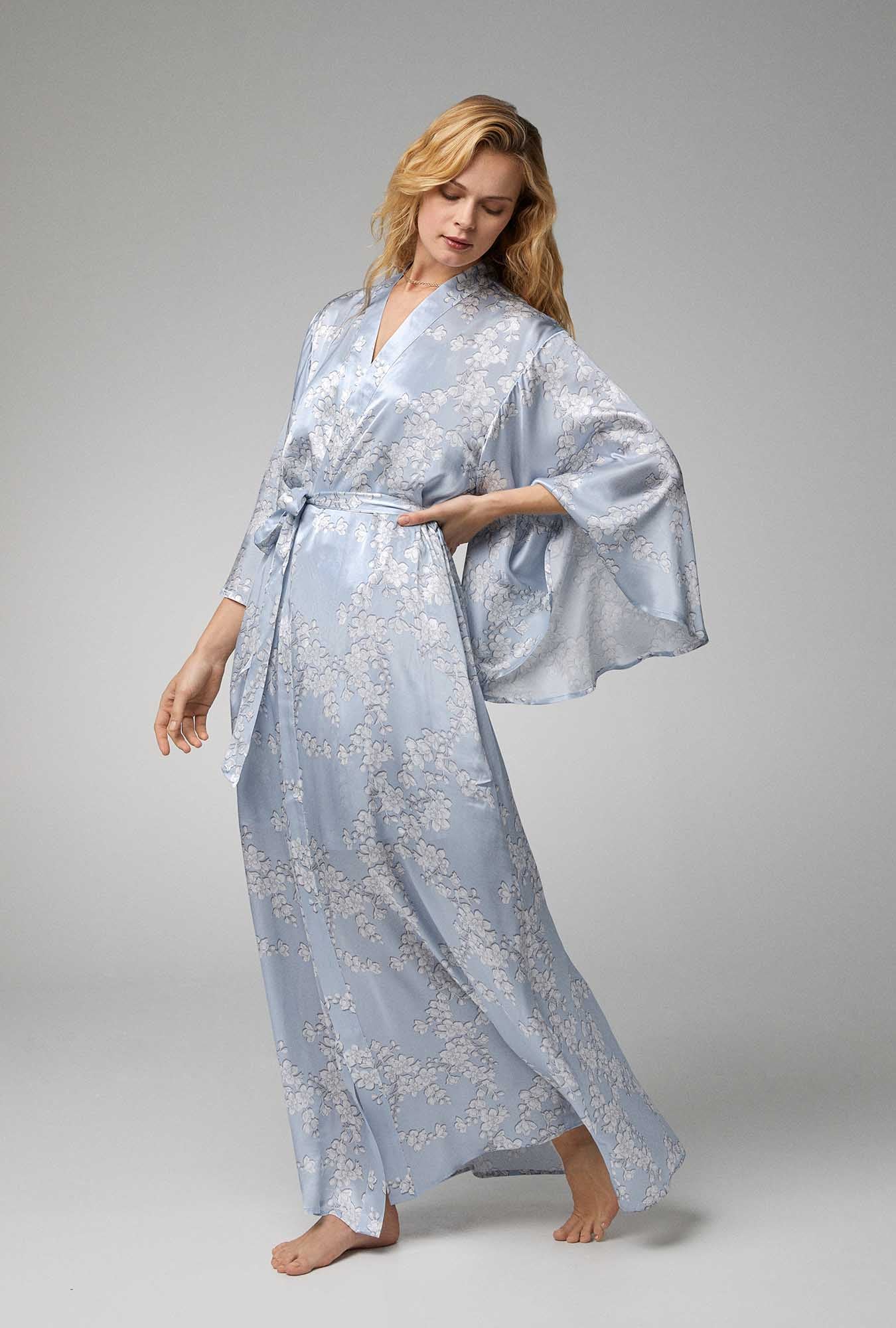 A lady wearing blue Banded Collar Woven Silk Satin Maxi Robe with Renee's Blossom print