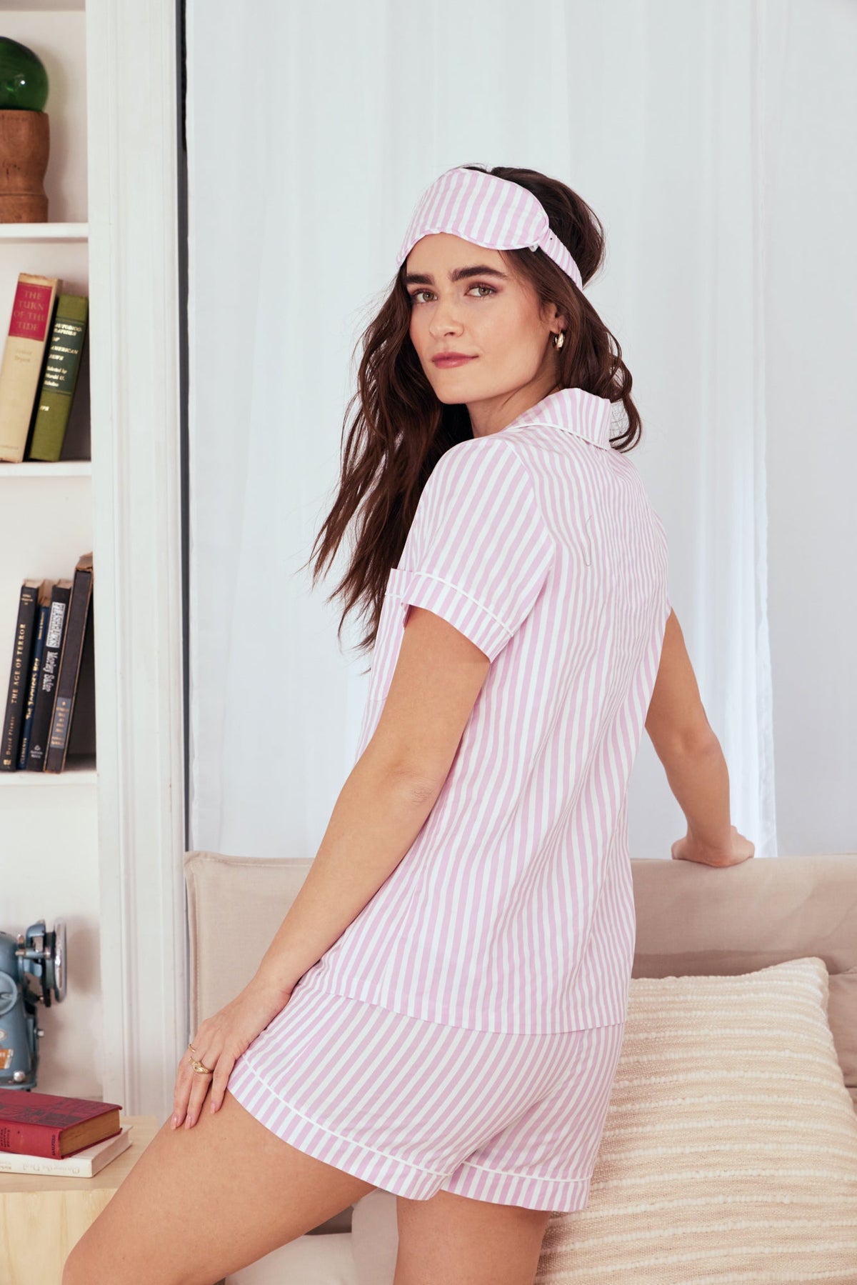 A lady wearing a pink and white stripes short sleeve shorty pj set.