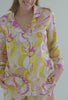 A lady wearing floral long sleeve classic washable pj set with trina turk print