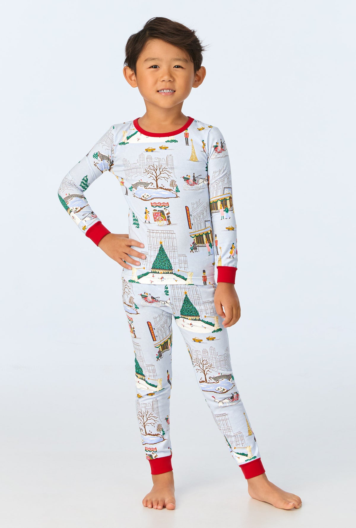 A child wearing Holiday In The City Long Sleeve Stretch Jersey Kids PJ Set