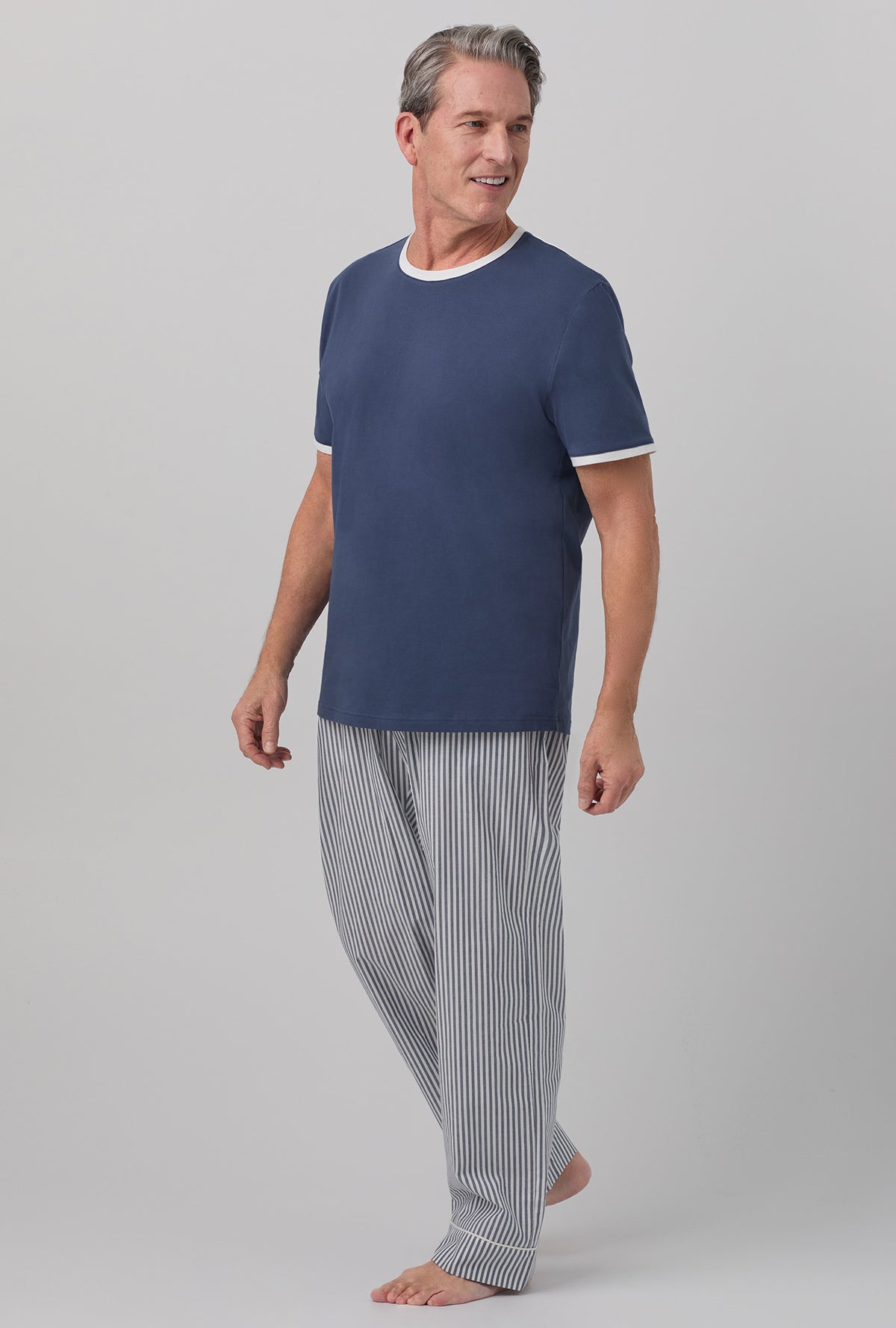 A man wearing blue short sleeve tee pj set with blue south shore stripe print.