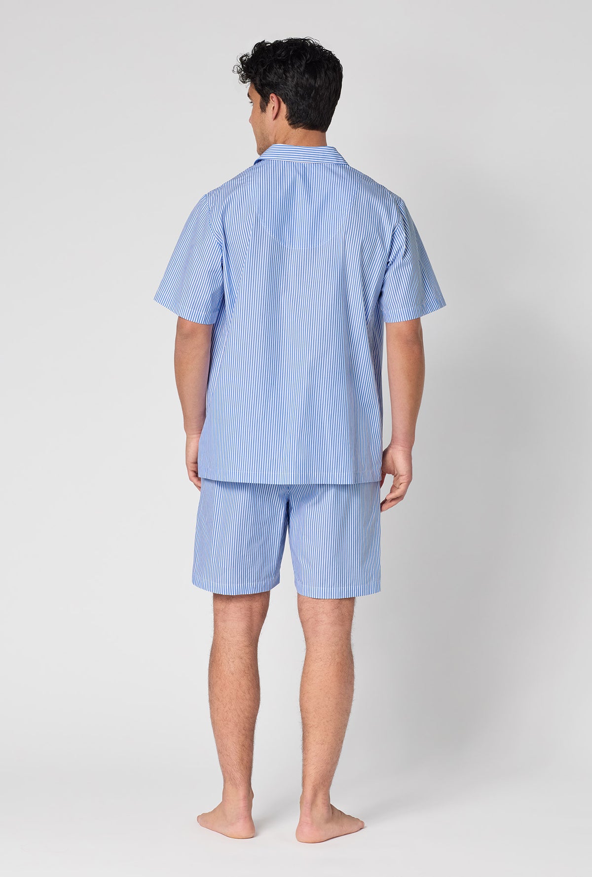 A Man Wearing French Stripe Men's Short Sleeve Woven Supersoft Cotton Poplin Short Pj Set in a back view pose
