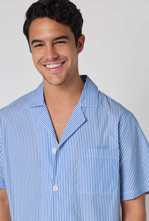 A Man Wearing French Stripe Men's Short Sleeve Woven Supersoft Cotton Poplin Short Pj Set in a close up smiling pose