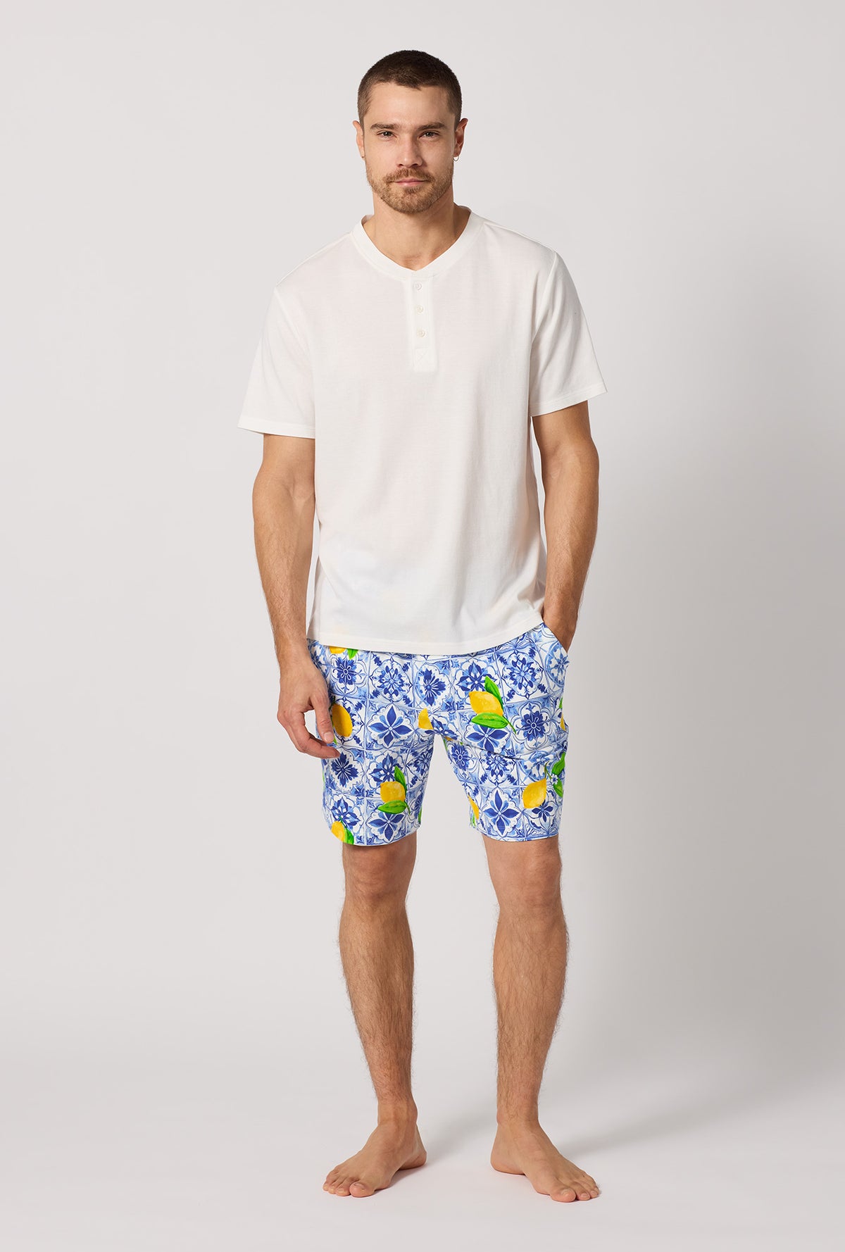 A man wearing Blue and  White Men's Short Sleeve Henley Stretch Jersey Short Pj Set front view