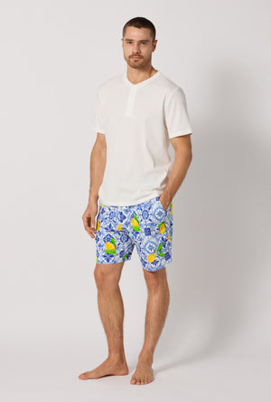 A man wearing Blue and  White Men's Short Sleeve Henley Stretch Jersey Short Pj Set side view