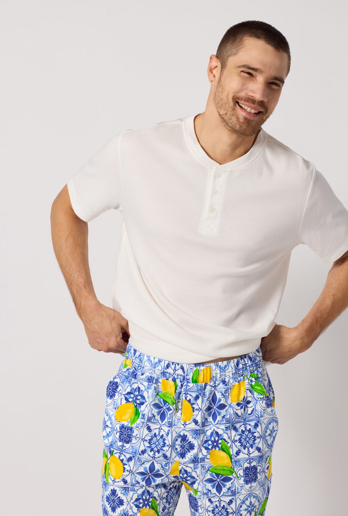 A closeup of A man wearing Blue and  White Men's Short Sleeve Henley Stretch Jersey Short Pj Set