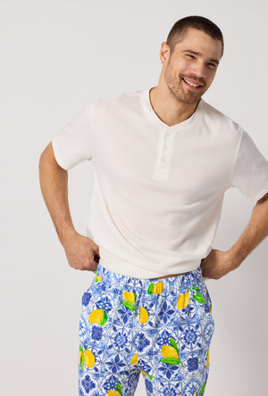 A closeup of A man wearing Blue and  White Men's Short Sleeve Henley Stretch Jersey Short Pj Set
