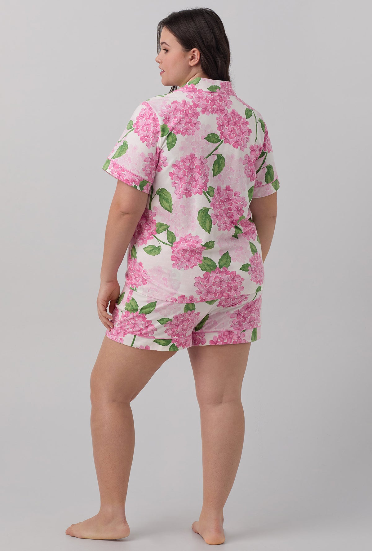 A lady wearing plus size pink  Short Sleeve Classic Shorty Stretch Jersey PJ Set with Grand Hydrangea print.