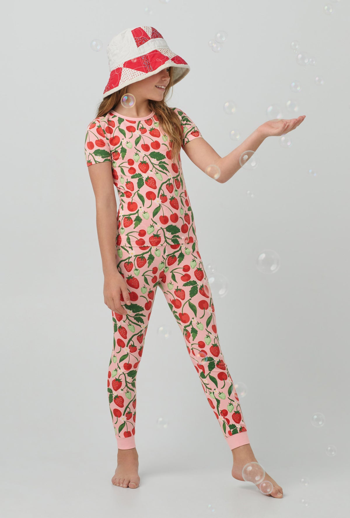 A girl wearing Short Sleeve Stretch Jersey Kids PJ Set with berry bliss print