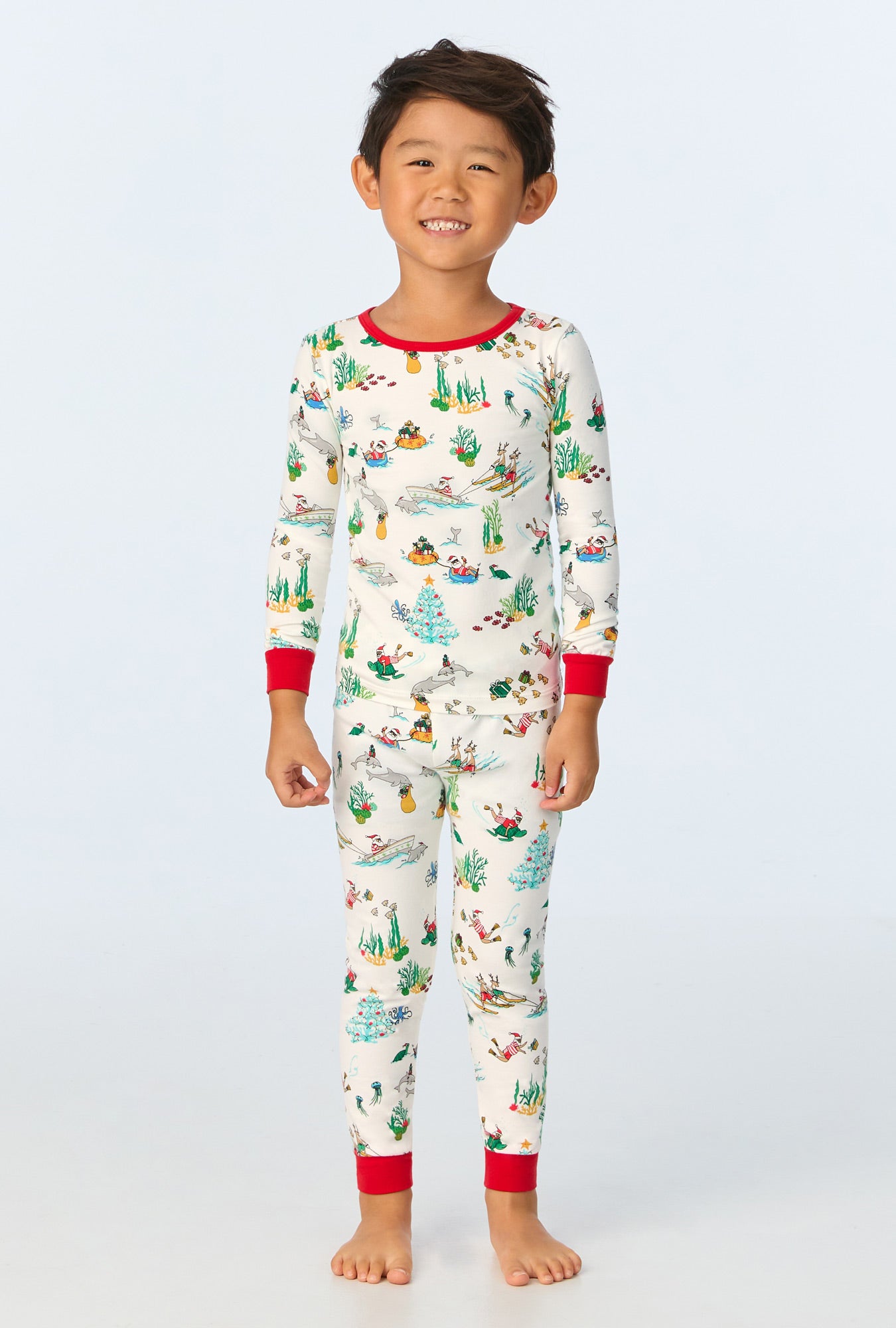 A child wearing Tis The Sea-Son Long Sleeve Stretch Jersey Kids PJ Set