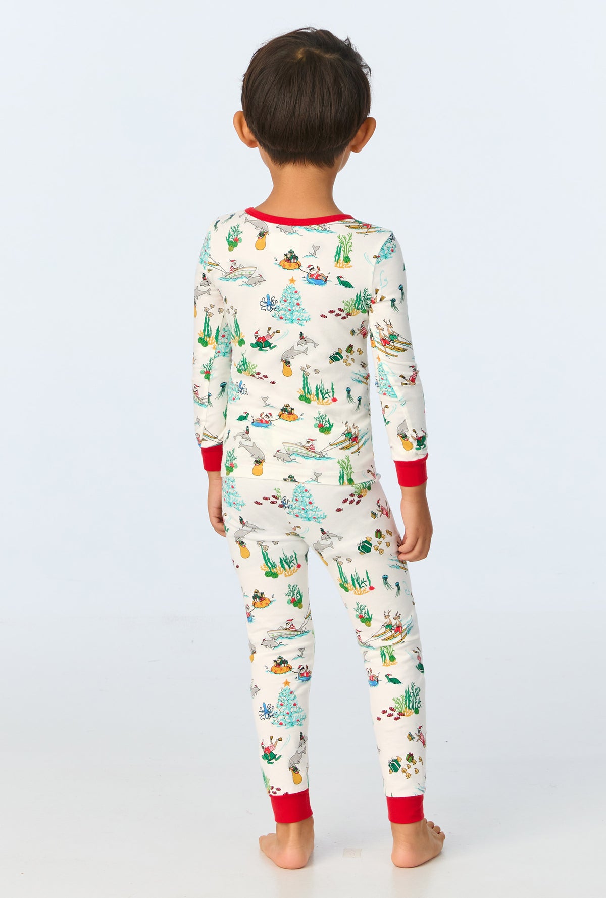 A child wearing Tis The Sea-Son Long Sleeve Stretch Jersey Kids PJ Set