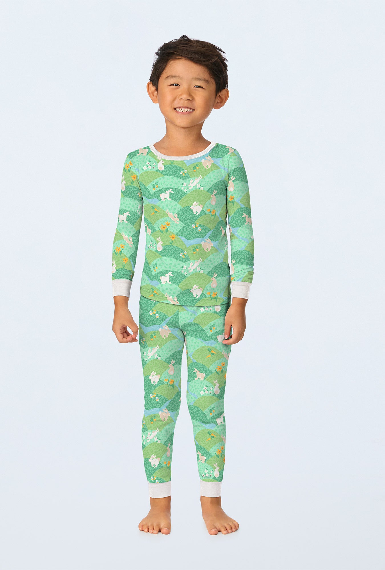 A boy wearing Hop To It Long Sleeve Stretch Jersey Kids PJ Set